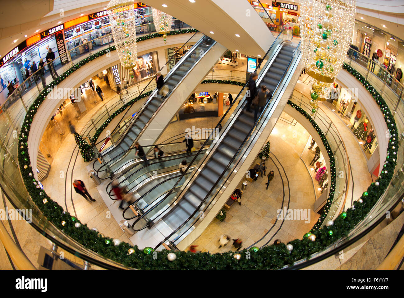 Dresden, Germany. 20th Nov, 2015. Customers at the Altmarkt-Galerie ride the escalators at the shopping center that has been decorated for Christmas in Dresden, Germany, 20 November 2015. Primarily gift cards, books, and jewelry are sold over the counter in the weeks before the holiday. Retailers in the city hope for a holiday rush - and lure shoppers with a Christmas atmosphere. Photo: ARNO BURGI/dpa/Alamy Live News Stock Photo