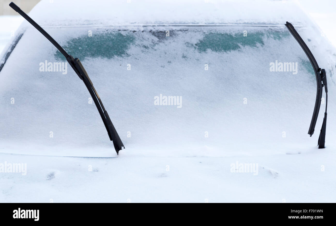 Windscreen Wipers on Snowy Car in winter time Stock Photo