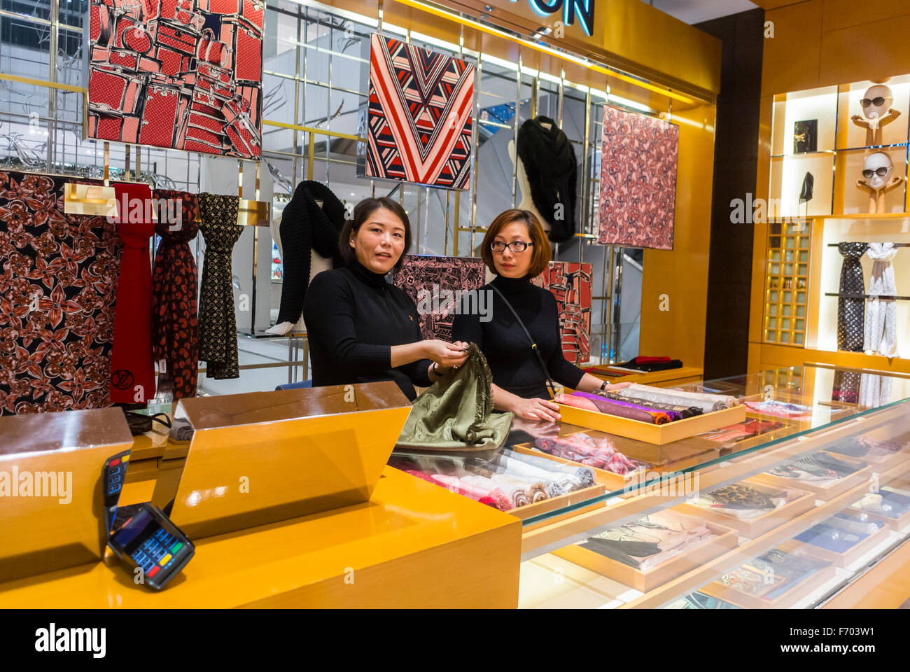 Paris, France, Chinese workers, Clerks Working in Louis Vuitton Store LVMH Luxury Shop, French Department Store counter, Printemps, designer label, haute couture accessories, shopping luxe Stock Photo