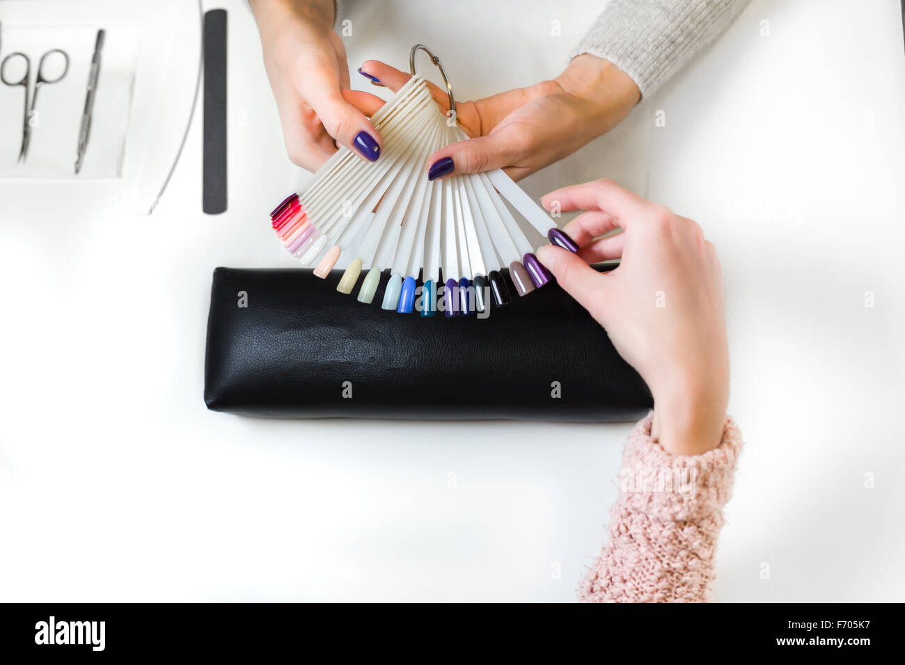 Woman chose cats-eye color shellac for nail Stock Photo