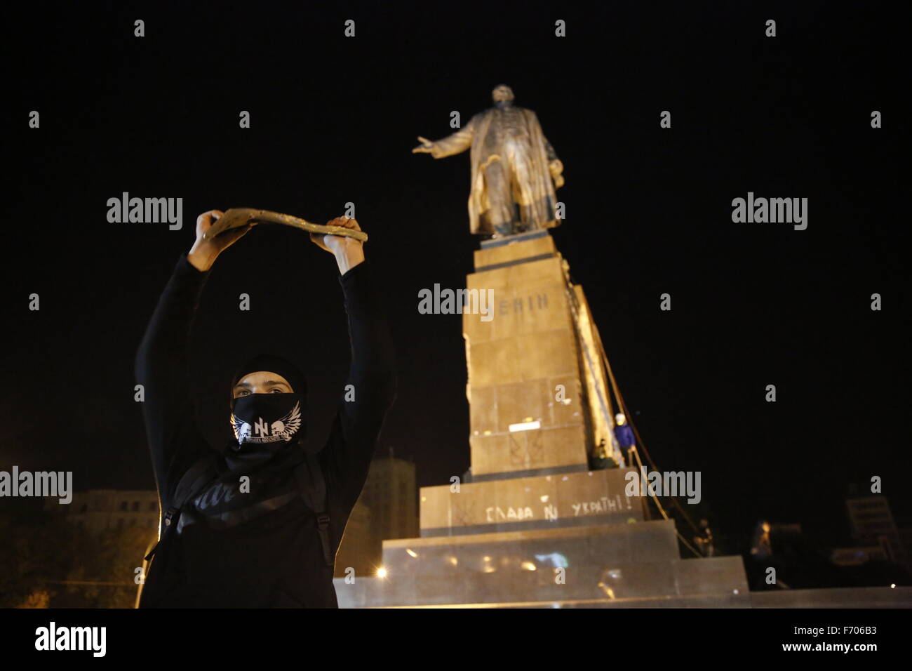 Ukrainianian protesters cut down the Lenin Statue on Freedom Square in Kharkiv, a predominately Russian speaking area. The statue, one of the largest in Ukraine, is on the largest square in the country. A member of the Azov Battalion holds a piece of the statue. Stock Photo