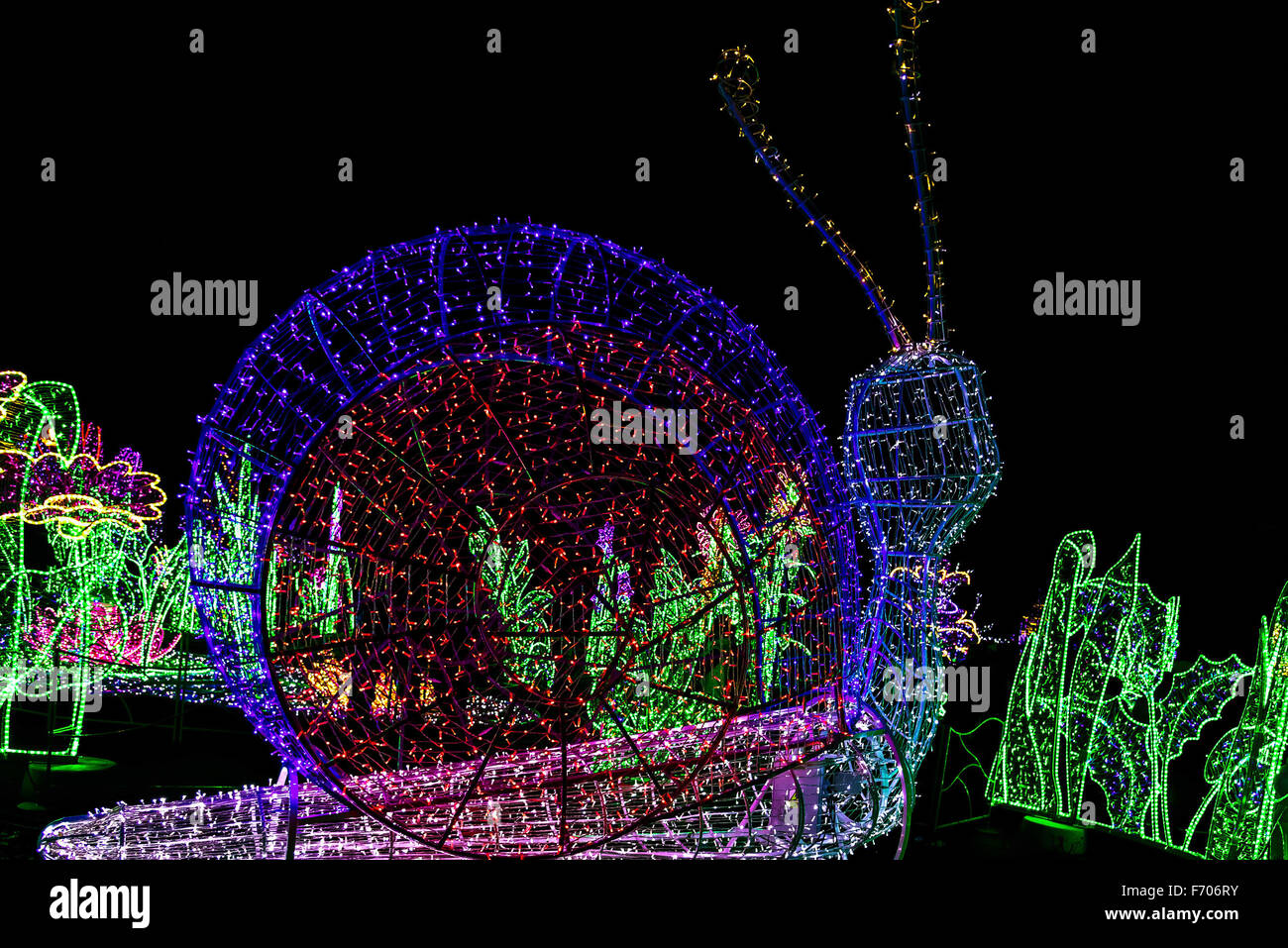 Construction in Form of Snail in Multicolored Christmas Lamps Stock Photo