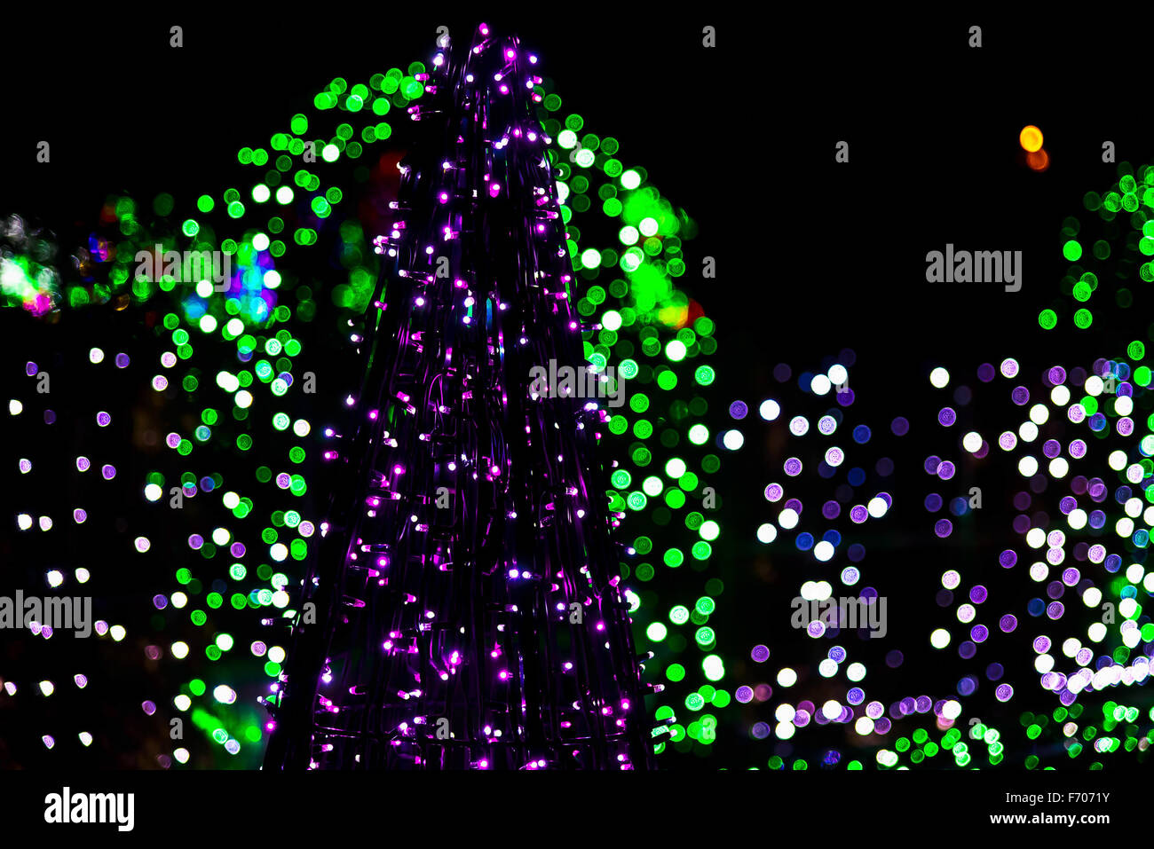 Figure of Christmas Tree from Garlands on Colorful Lights in the Background at Night Stock Photo