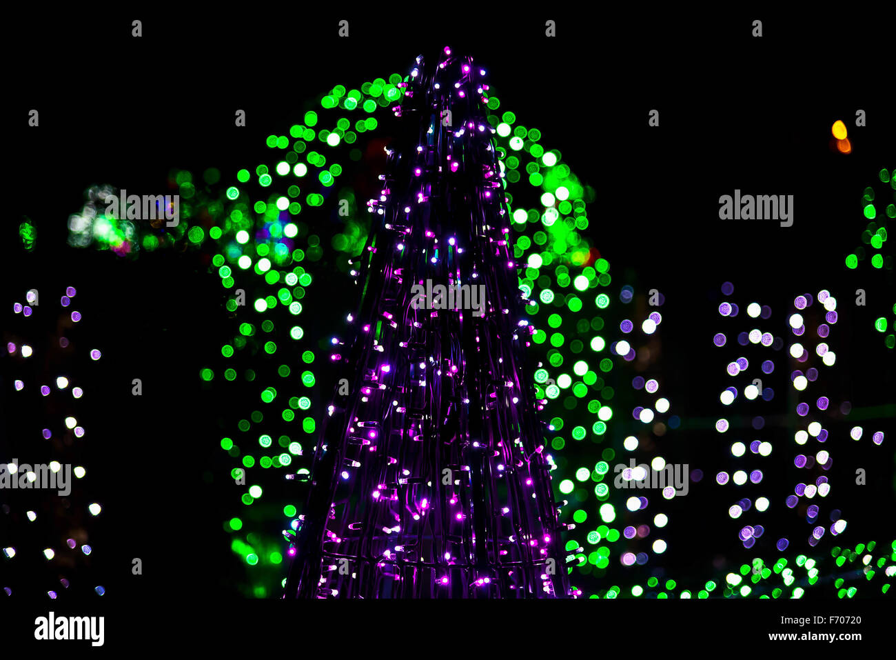 Christmas Tree made from Christmas Lighting Garland on Colorful Lights in Background Stock Photo