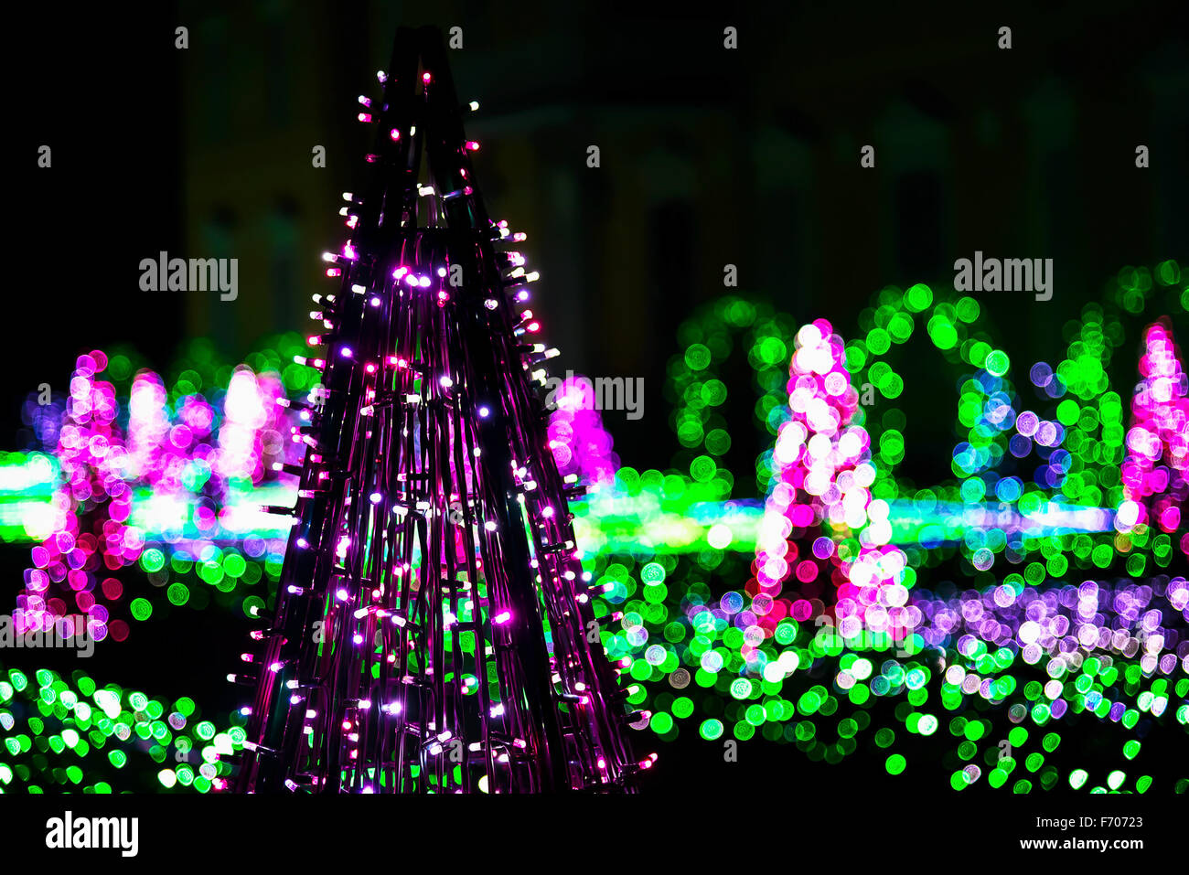 Garden of Colorful Lights with Sculptures of Purple Christmas Trees Stock Photo