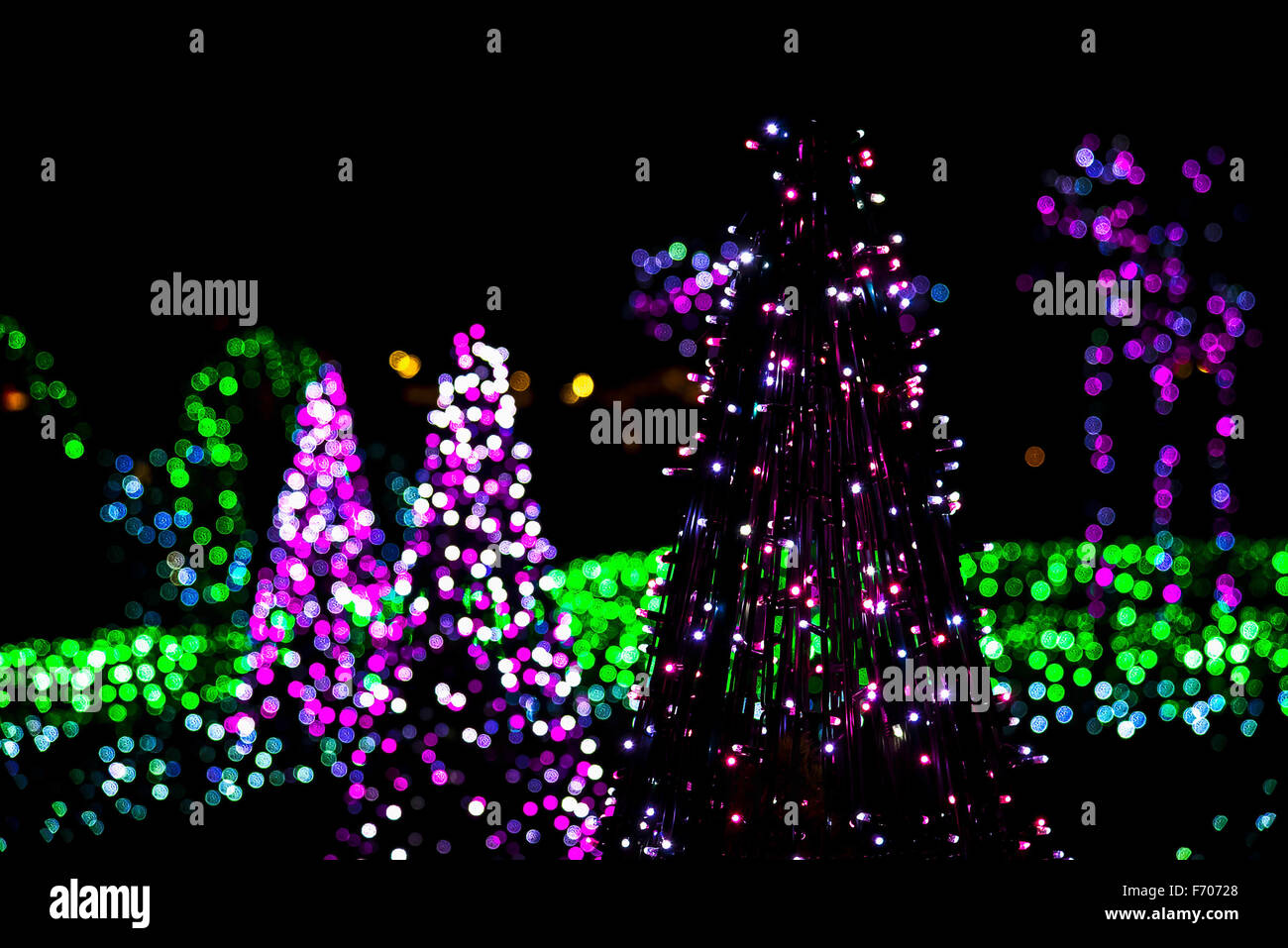 Christmas Tree made from Christmas Lighting Garland on Colorful Lights in Background Stock Photo