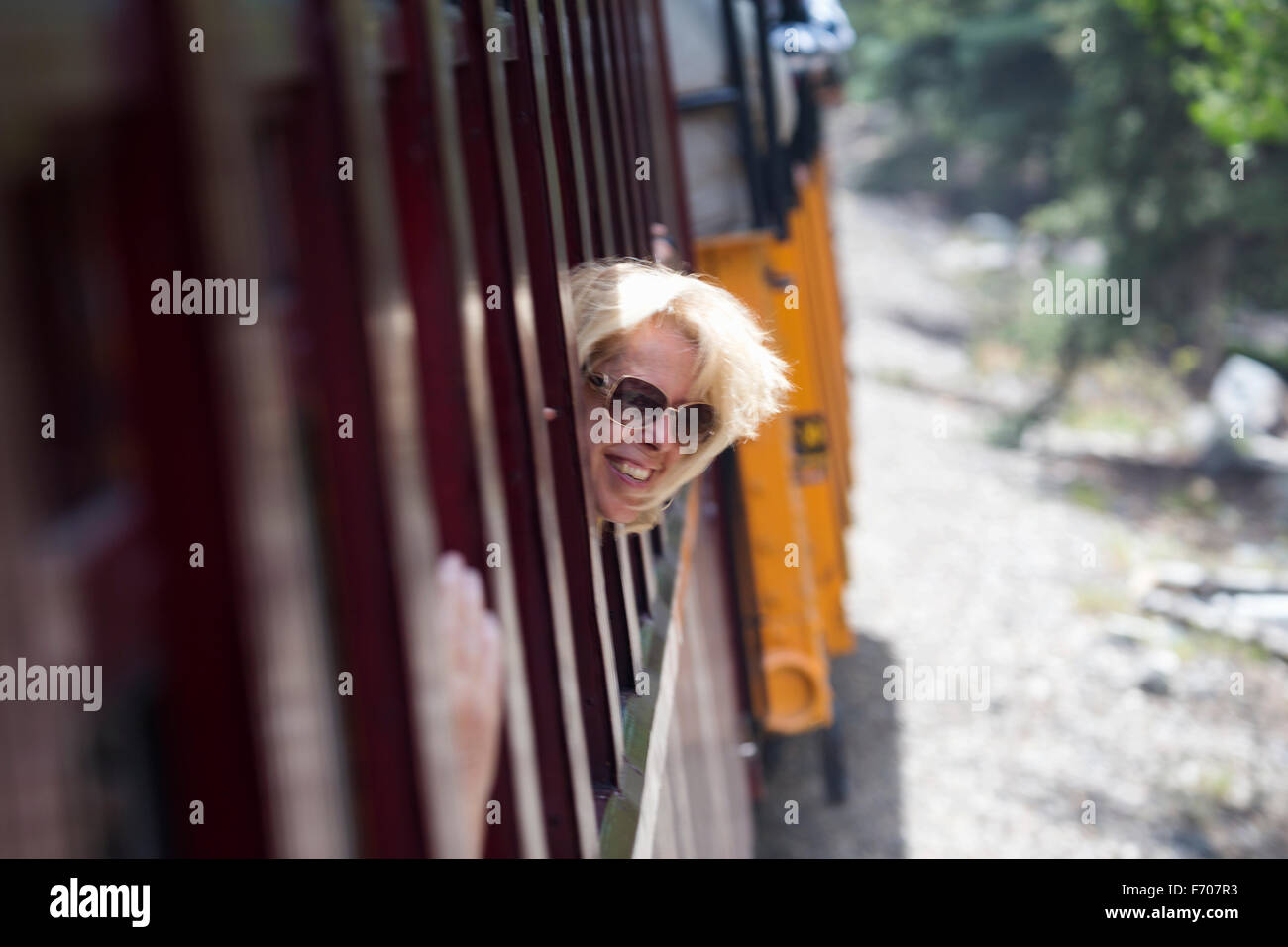 Leslie Plimpton sticks head out train window, antique train Silverton to Durango Colorado Stock Photo