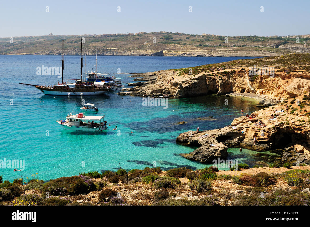 Excursion boats moored in the Blue Lagoon of Comino, Malta Stock Photo