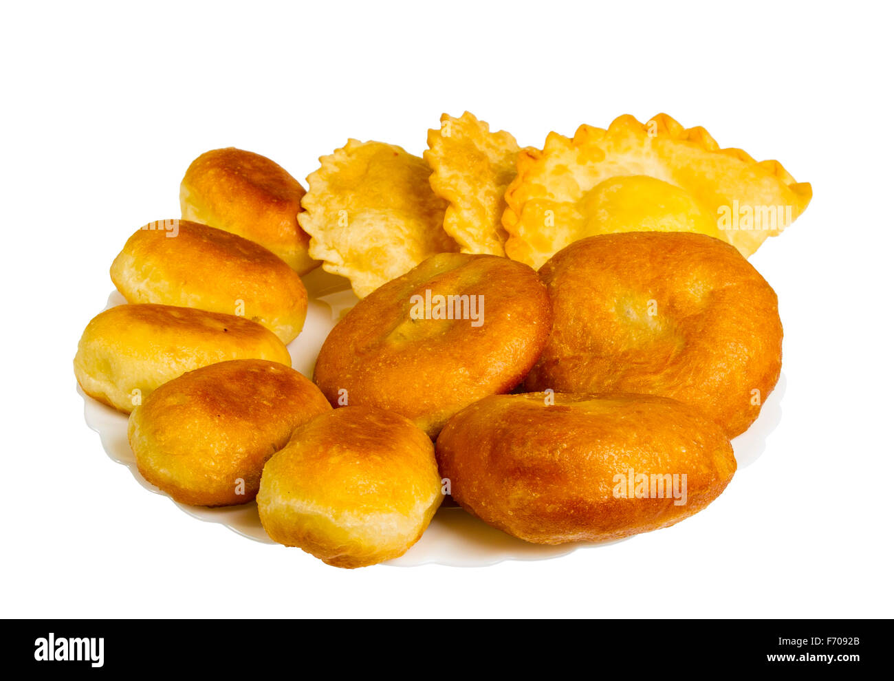 fried pies and pasties on the plate, isolated on white background Stock Photo