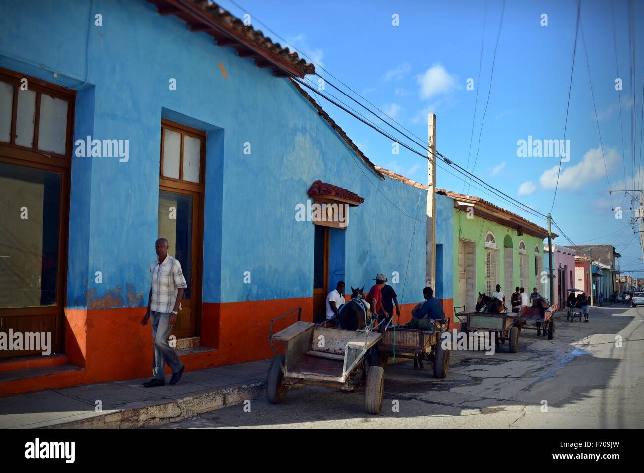 man walking and local transport parked in the shade in Trinidad Sancti Spiritus Province in Southwest Cuba Stock Photo