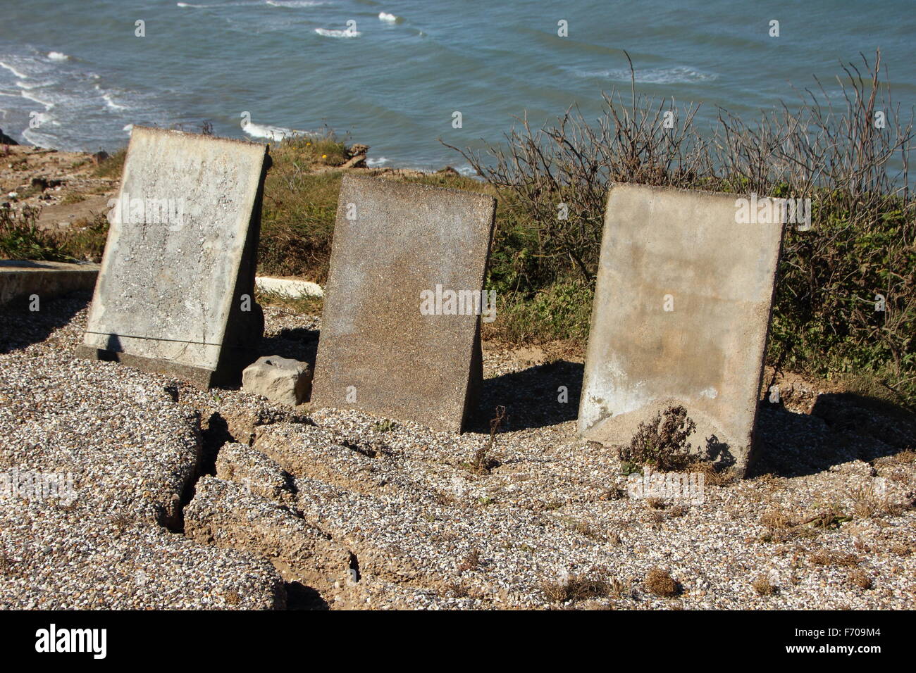 Three Headstones at Edge of Cliff with Ocean Background Stock Photo