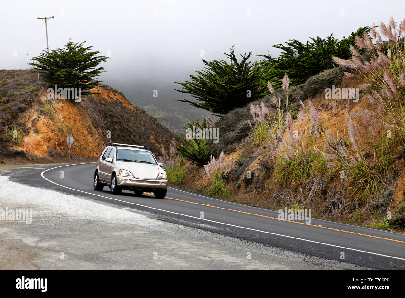 Road in the fog leading to Half Moon Bay, California Stock Photo