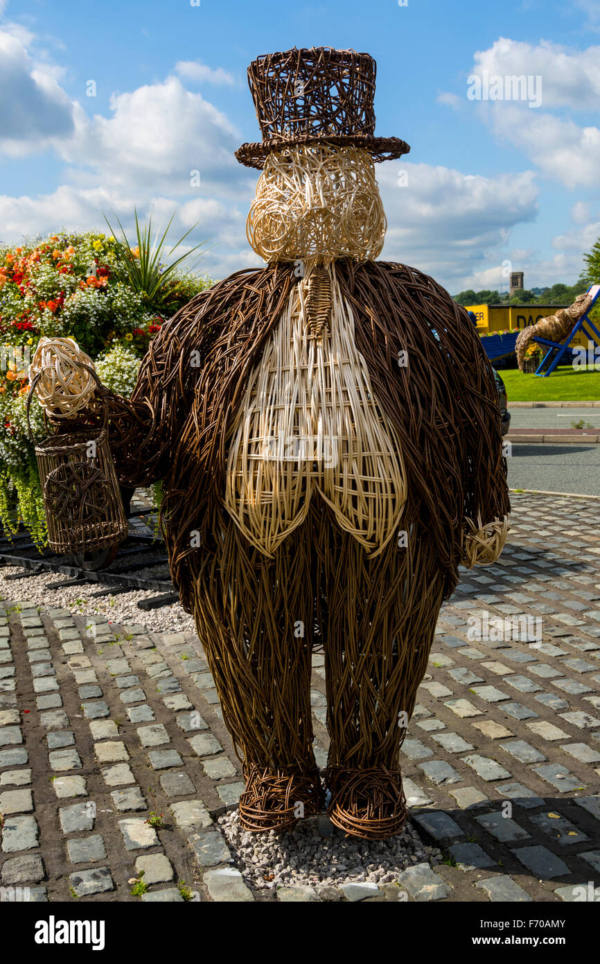 Sculpture by Cherry Chung of a fat man with a top hat, from willow, for 'Bury in Bloom', Bury, Greater Manchester, England, UK Stock Photo