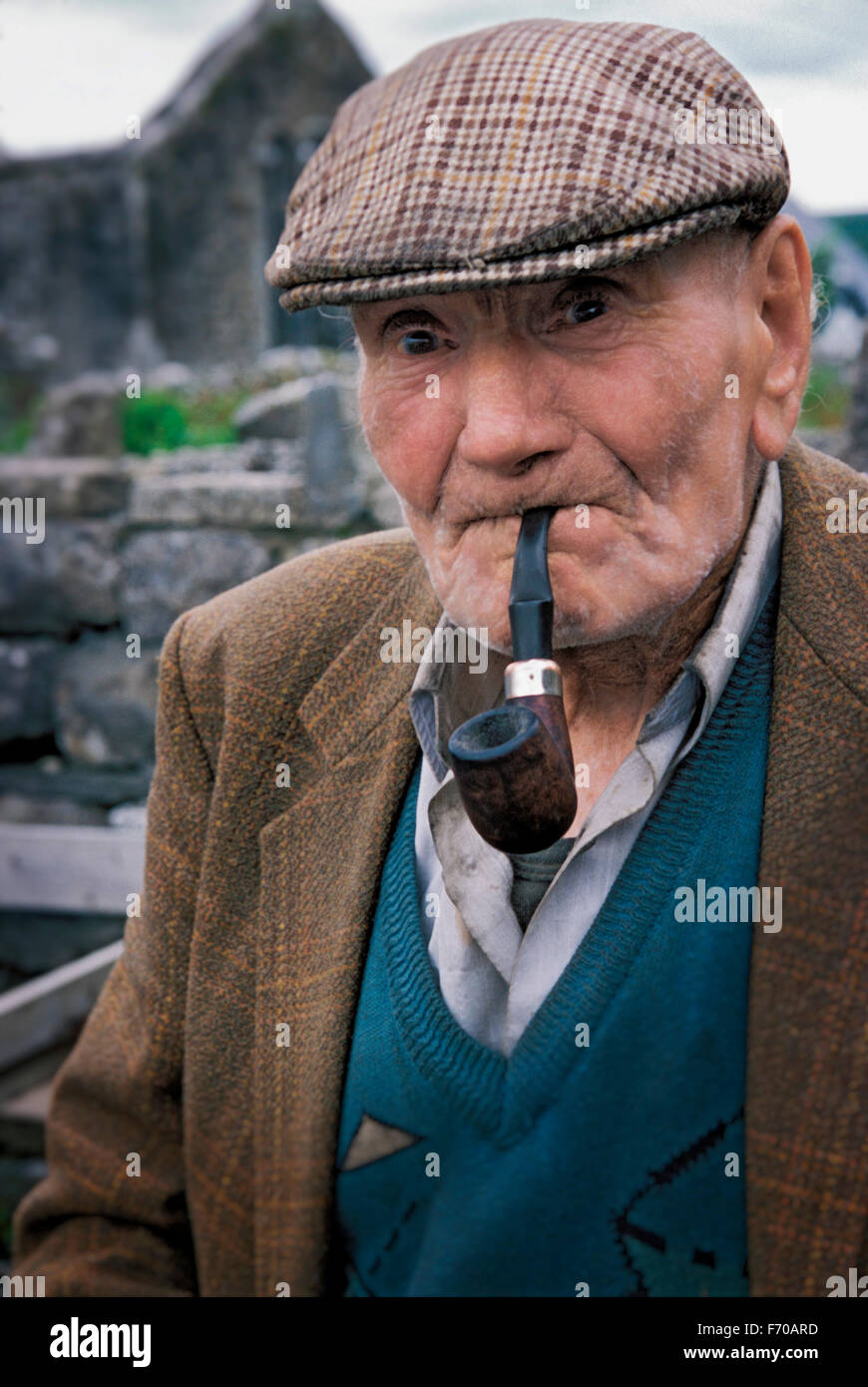 An Irish man smokes his pipe. Burren, Ireland. Stock Photo