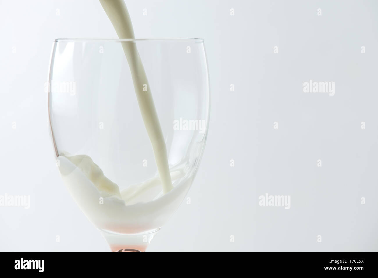 milk being poured into a glass Stock Photo Alamy