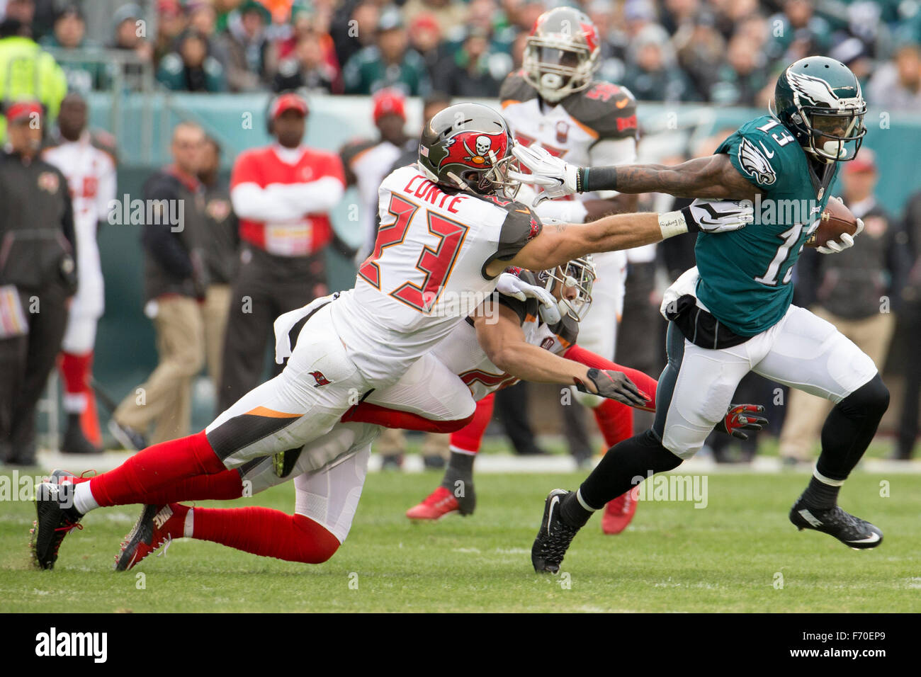 Philadelphia, Pennsylvania, USA. 22nd Nov, 2015. Philadelphia Eagles wide receiver Josh Huff (13) runs away from Tampa Bay Buccaneers strong safety Chris Conte (23) and cornerback Sterling Moore (26) as he heads towards a touchdown during the NFL game between the Tampa Bay Buccaneers and the Philadelphia Eagles at Lincoln Financial Field in Philadelphia, Pennsylvania. The Tampa Bay Buccaneers won 45-17. Christopher Szagola/CSM/Alamy Live News Stock Photo