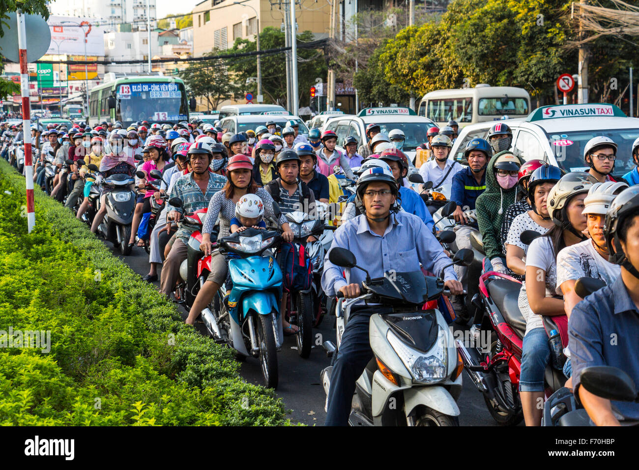 HO-CHI-MINH-CITY, VIETNAM - March 06, 2015: A massive amount of scooters driving in one of the main streets in the center of Saigon/Ho-Chi-Minh-City. It is afternoon, rush hour. Stock Photo