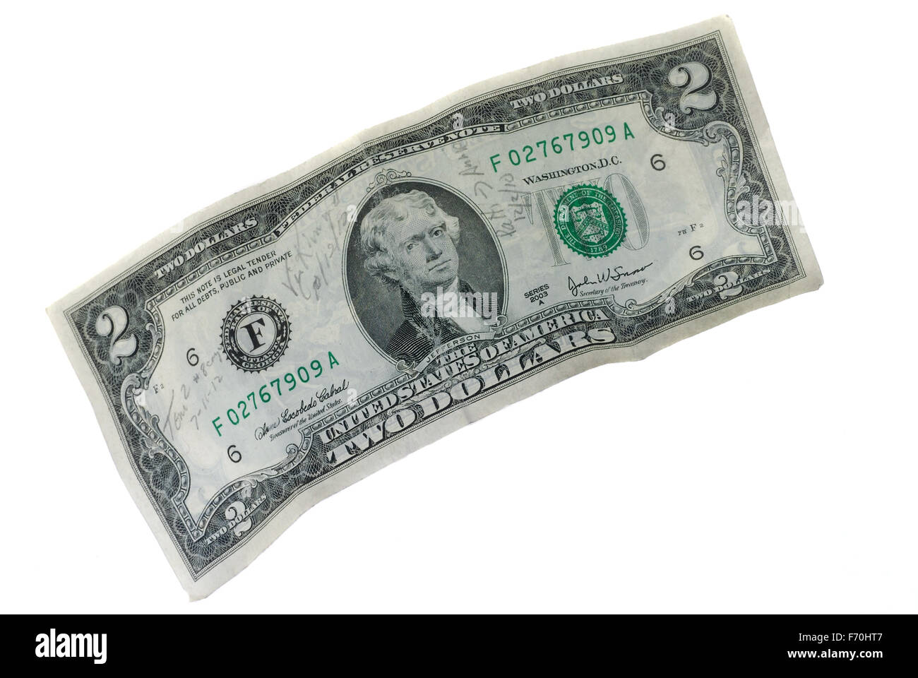 Old $2 bill with handwriting on a white background Stock Photo