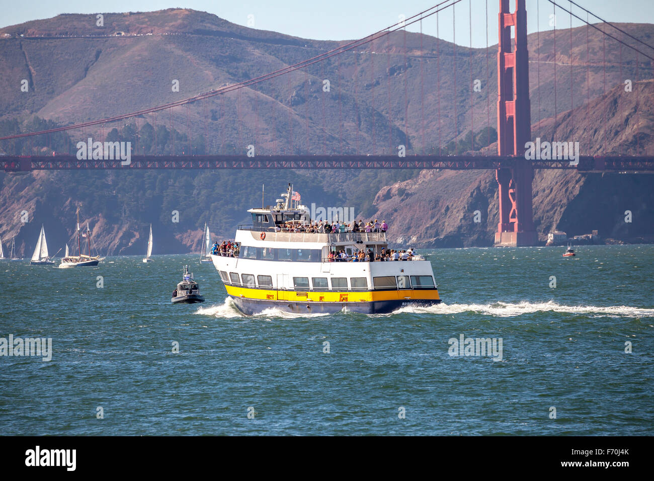 Blue and Gold ferry transporting passengers across the San Francisco Bay under Golden Gate Bridge San Francisco, California, USA Stock Photo