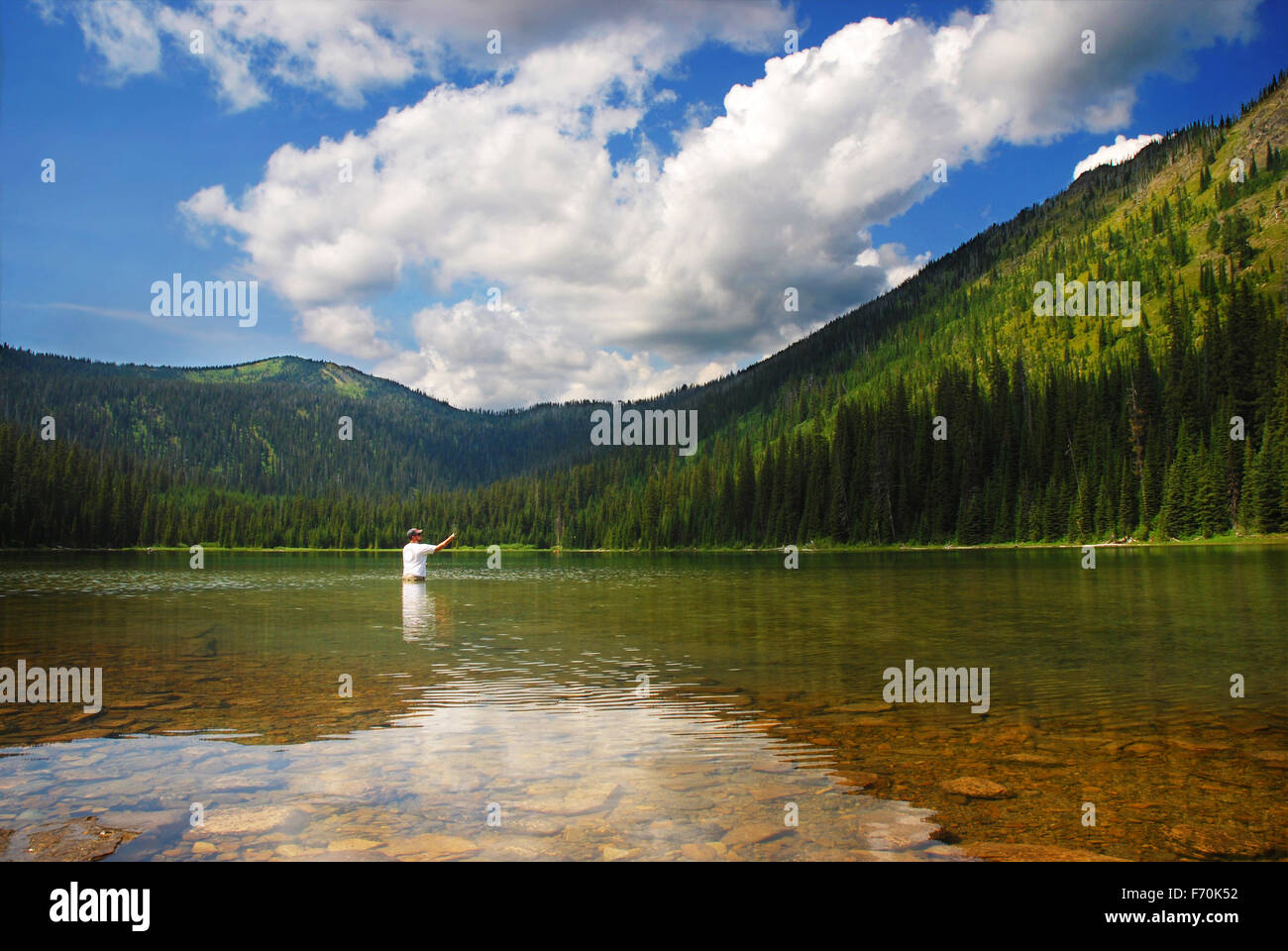 Man fishing at Moose Lake near Kalispell and Whitefish, Montana Stock