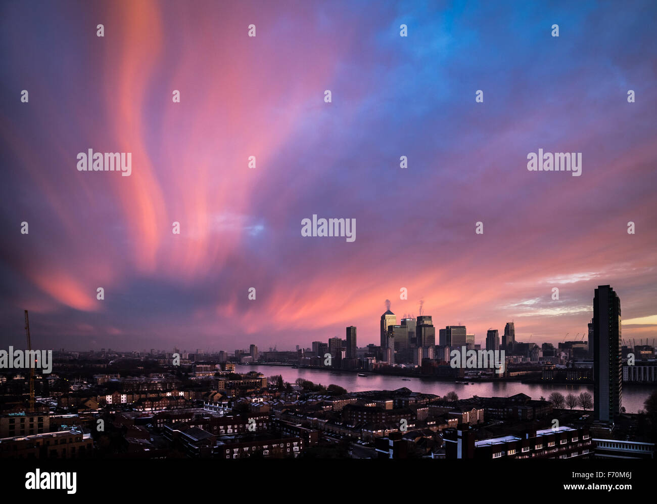 London, UK. 23rd November, 2015. UK Weather: cold air brings dramatic morning light sunrise over Canary Wharf business park buildings and River Thames Credit:  Guy Corbishley/Alamy Live News Stock Photo