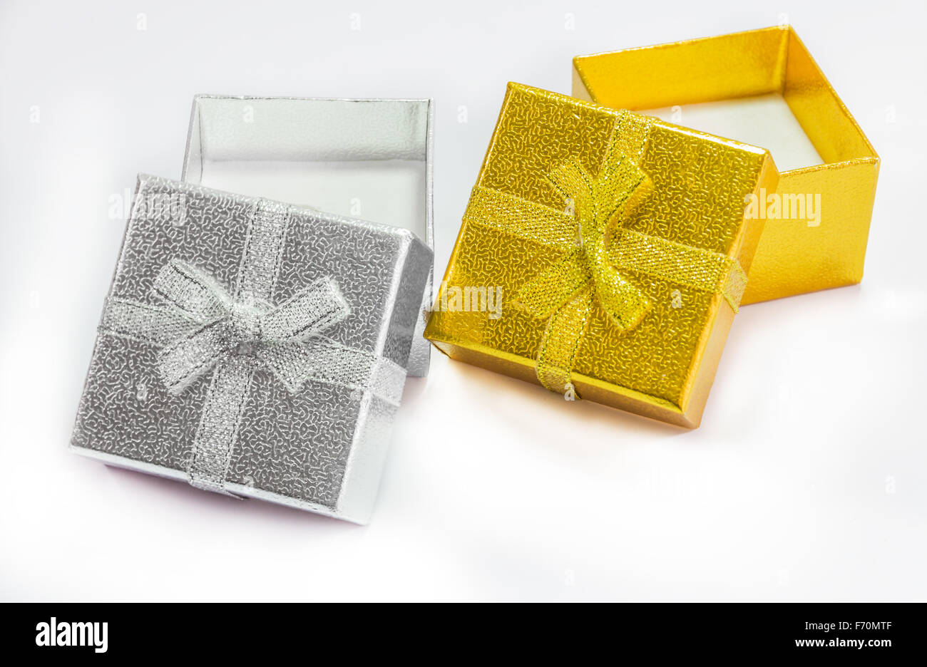 Golden and silver gift box with golden ribbon on white background Stock ...