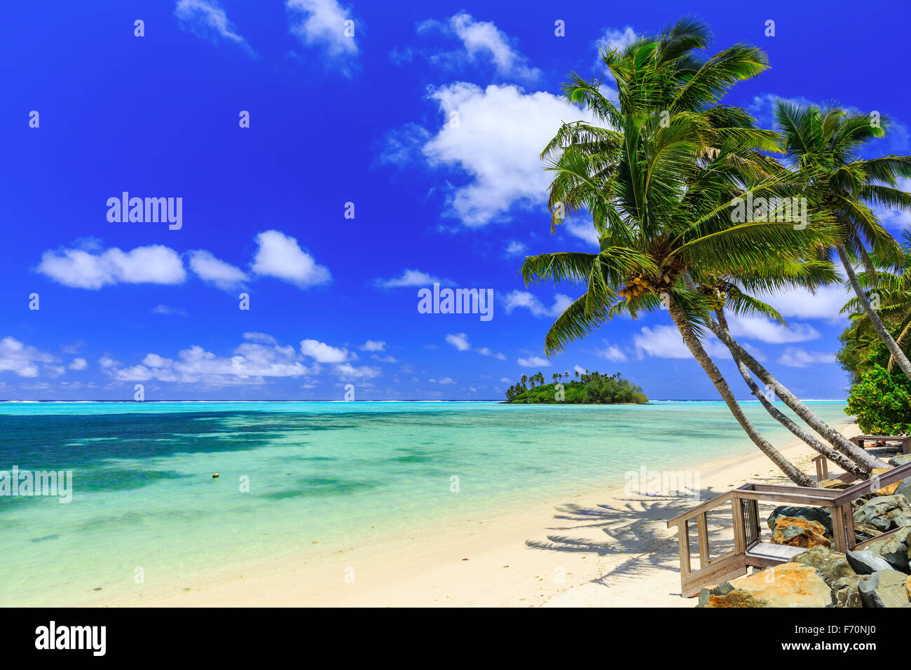 Beach with palm trees over tropical water at Muri lagoon, Rarotonga, Cook Islands Stock Photo