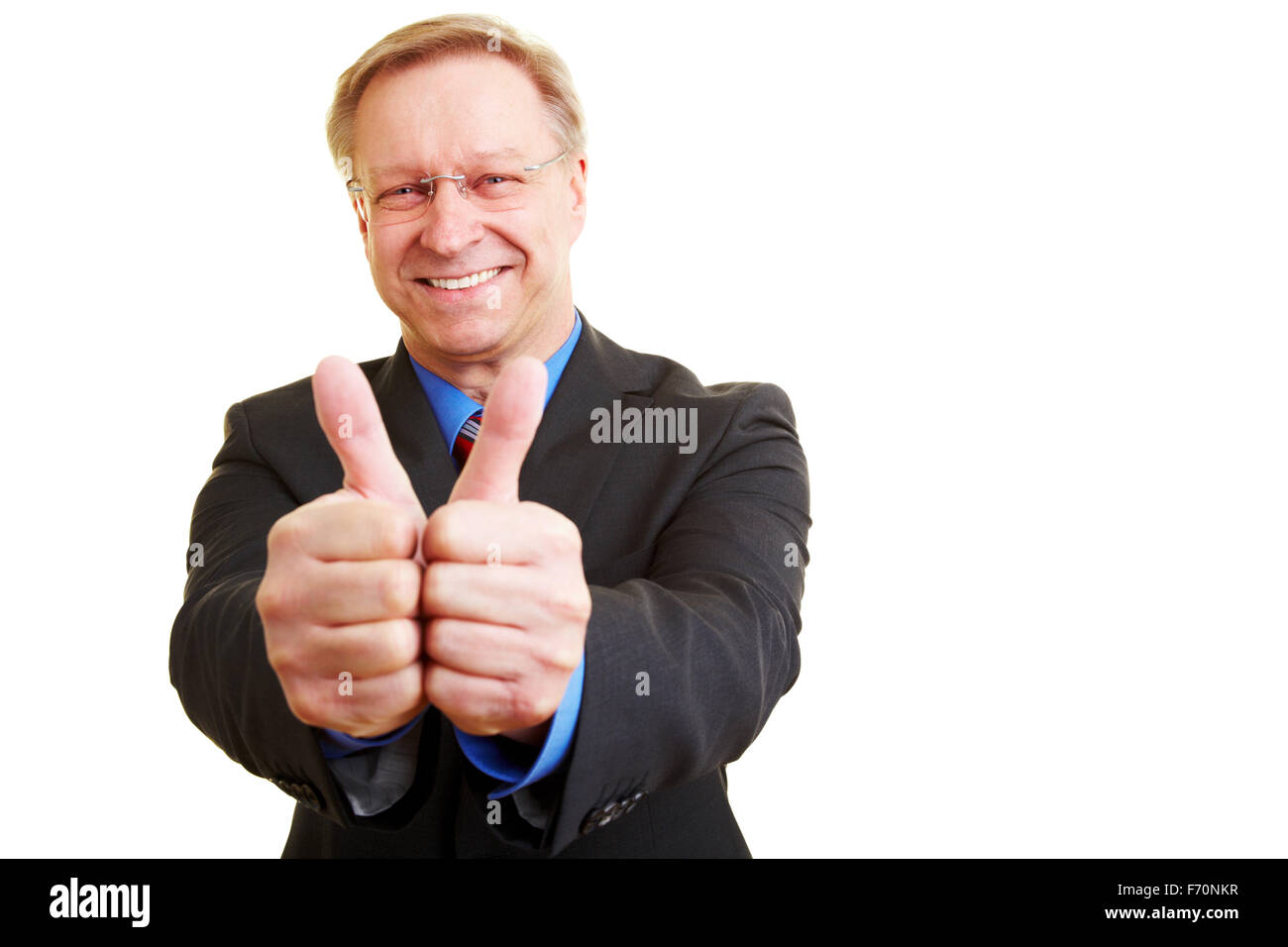 Senior businessman in a suit holding his thumbs up Stock Photo - Alamy