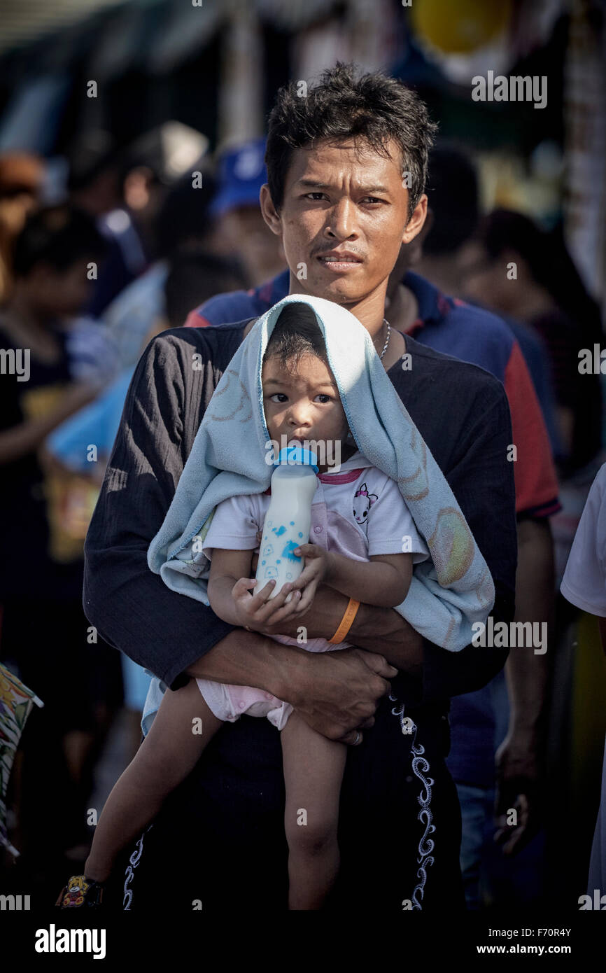 Man carrying baby hires stock photography and images Alamy