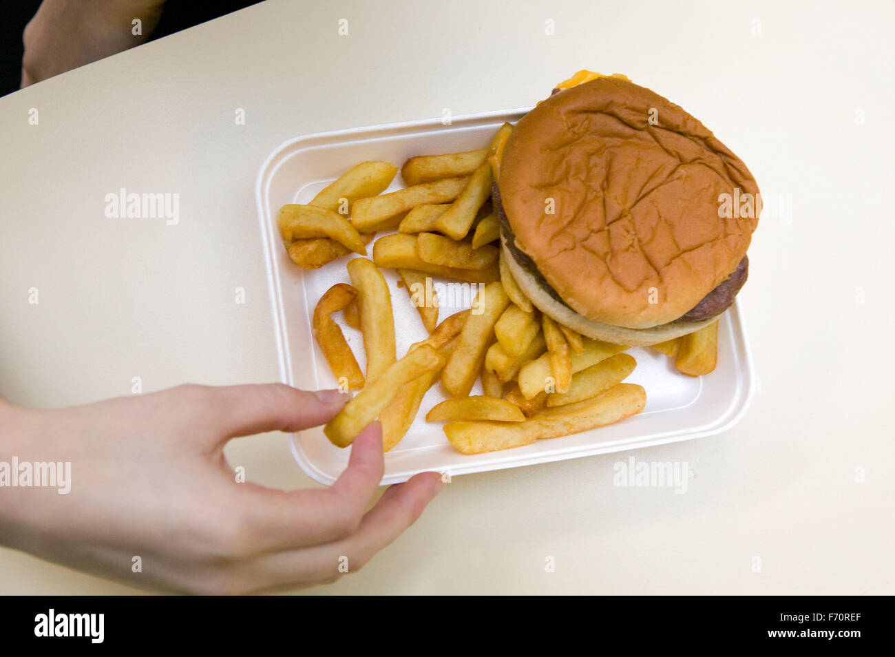 Unhealthy school meal of burger and chips; government guidelines encourage schools to replace less healthy options with more fre Stock Photo