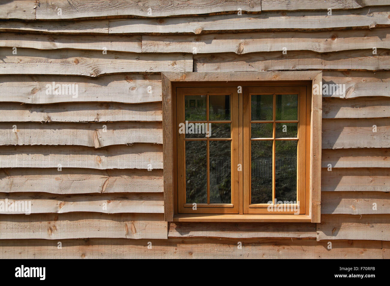 Wooden panelling facade of the Eco House at The Wintles; Bishop's Castle, Stock Photo