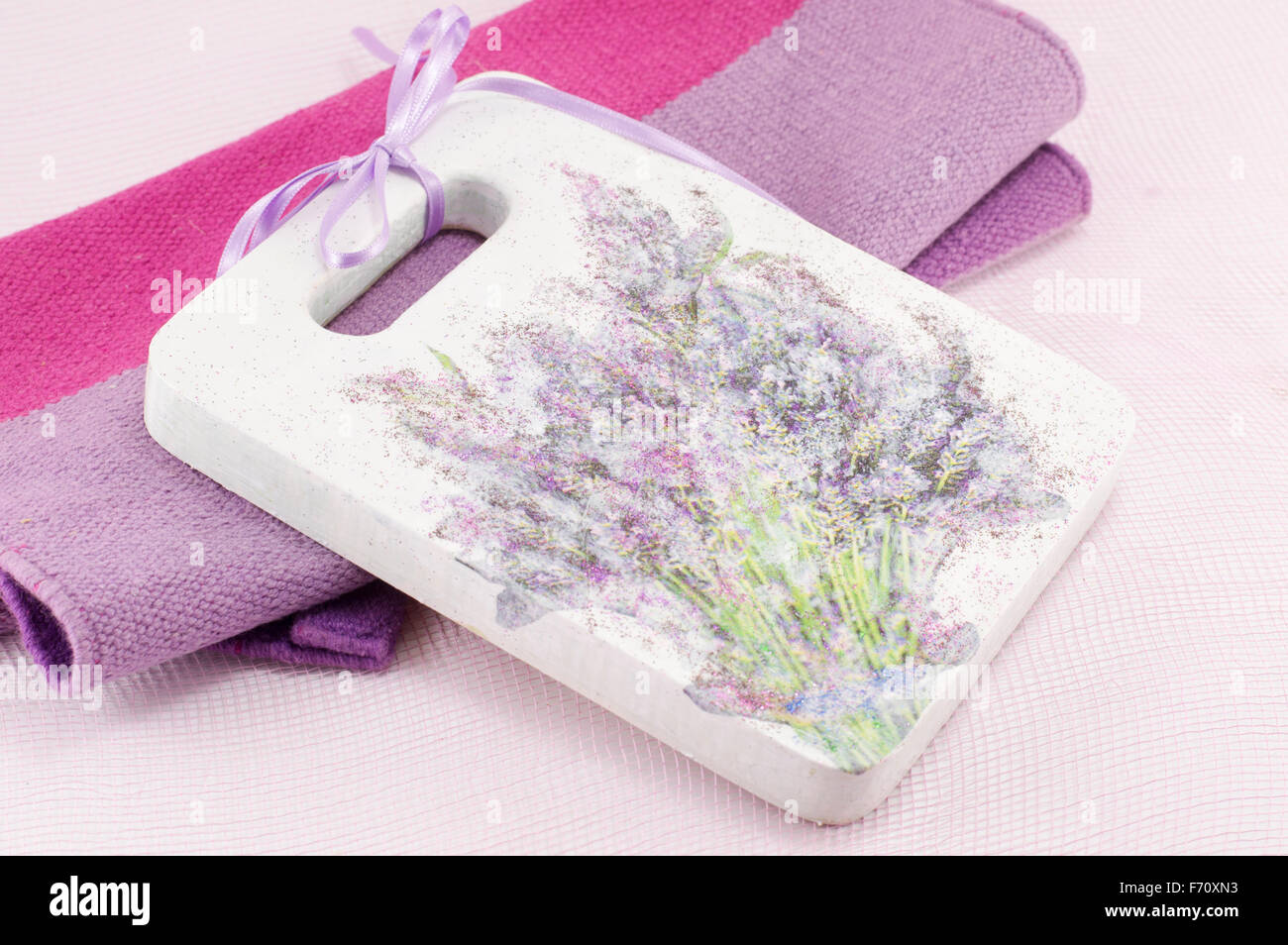 Decoupage decorated tray with flower pattern against soft pink background Stock Photo