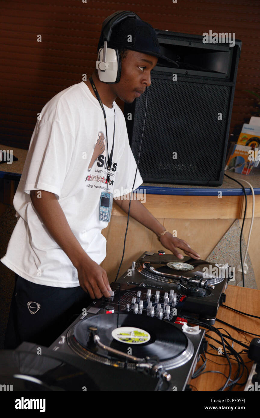 DJ mixing on decks at the St Anns; Nottingham Holding Hands festival