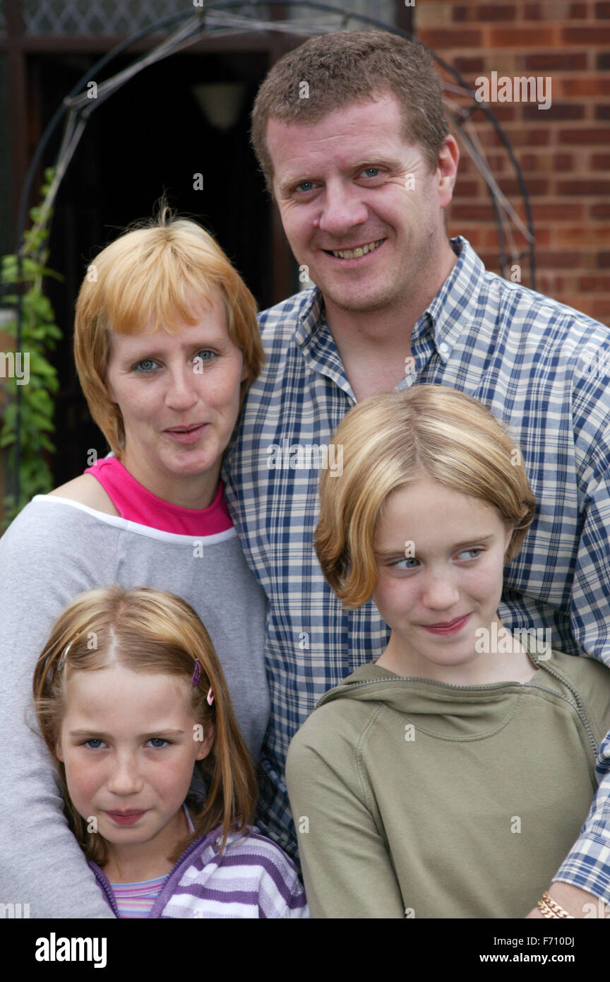 Family standing outside house together Stock Photo - Alamy