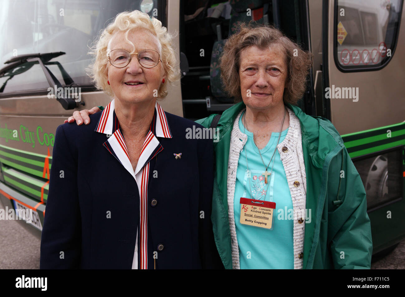 Two elderly women standing by a coach, Stock Photo