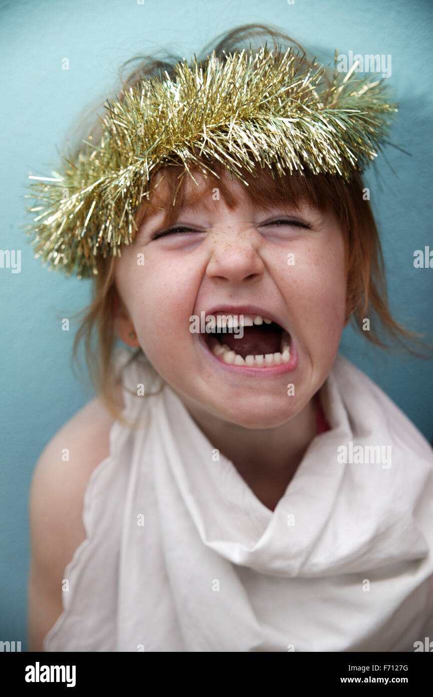 Portrait of a young girl with tinsel on her head, Stock Photo