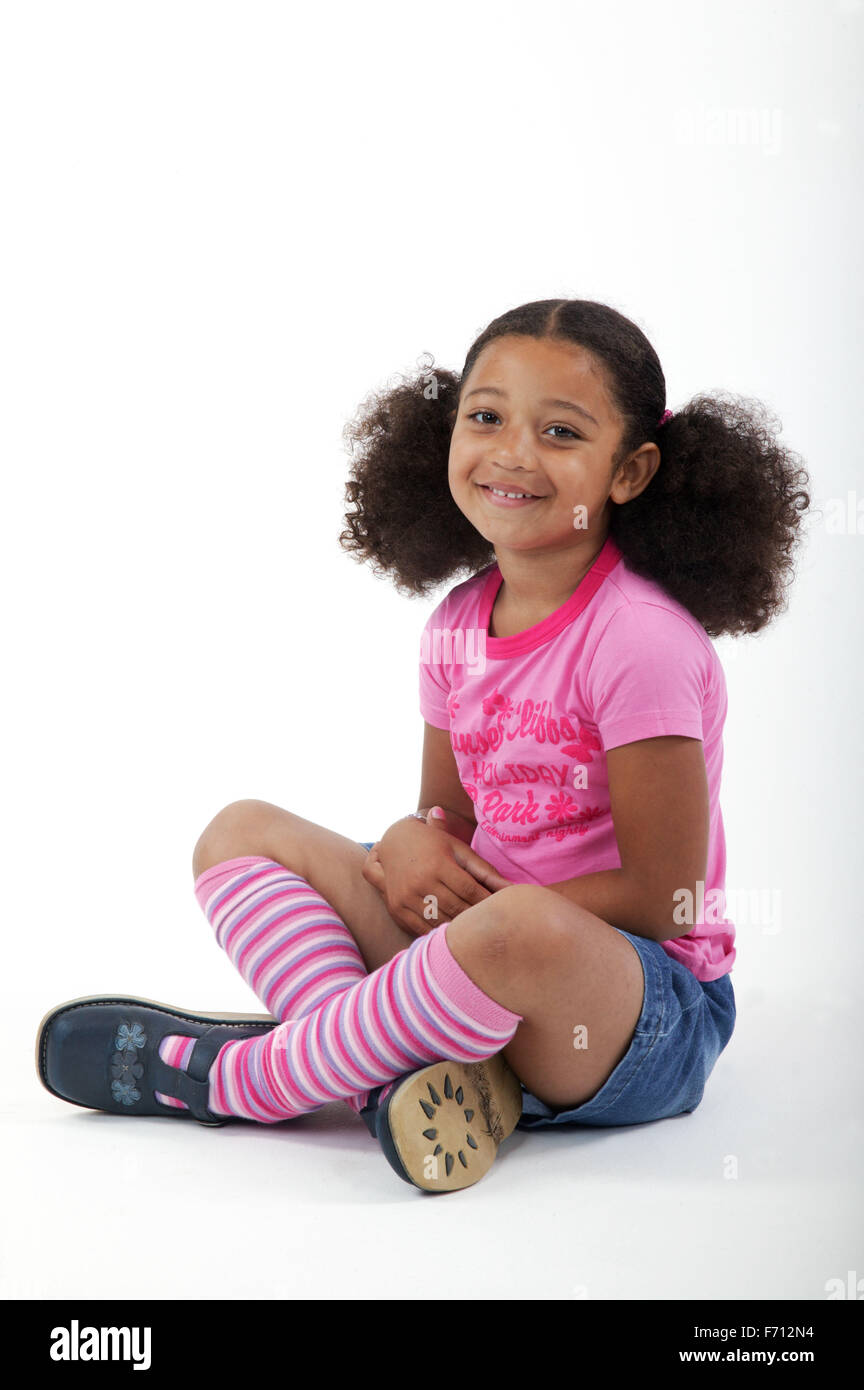 Young girl sitting cross legged on the floor Stock Photo - Alamy