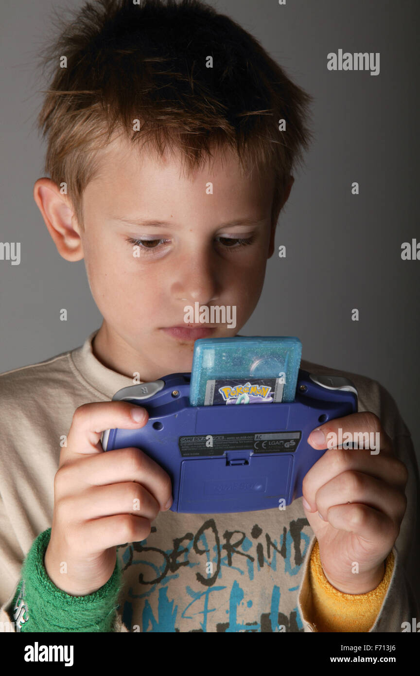 Portrait of a young boy playing with his Gameboy Stock Photo - Alamy