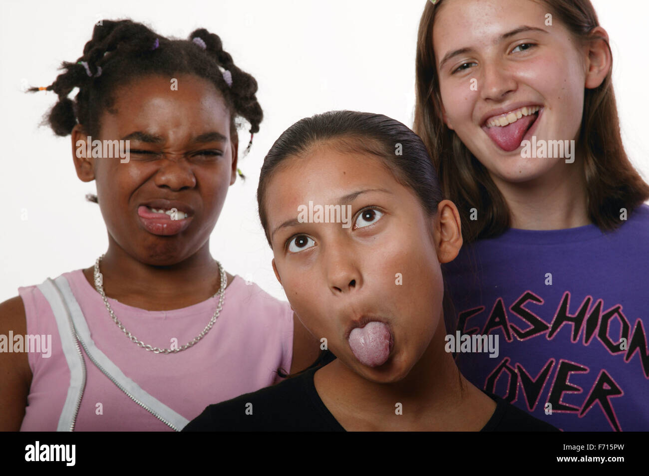 Multiracial group of teenage girls pulling funny faces, Stock Photo