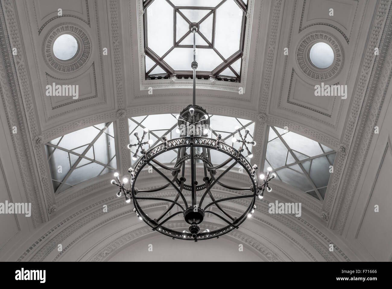 Ornate neoclassical Ceiling with hanging iron chandelier, Stock Photo