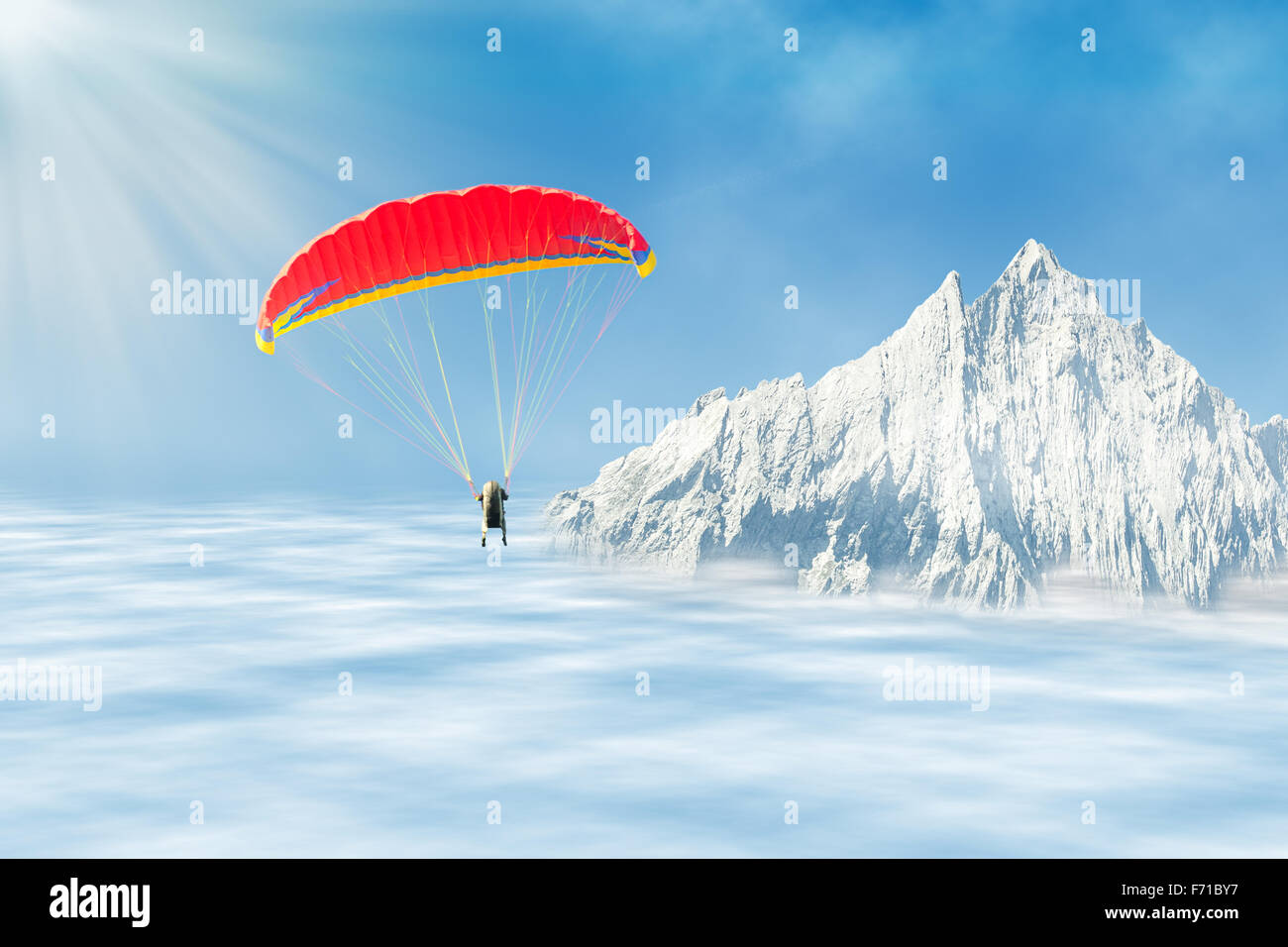 Freestyle solo paragliding at high altitude in the sky over clouds against mountain peak Stock Photo