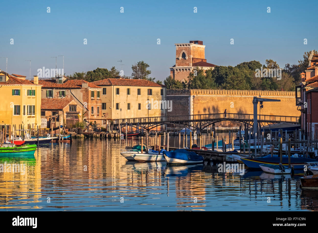 Venice, Castello, Sestiere, Italy - Harbour view - Traditional houses, boats, reflections and warm colours Stock Photo