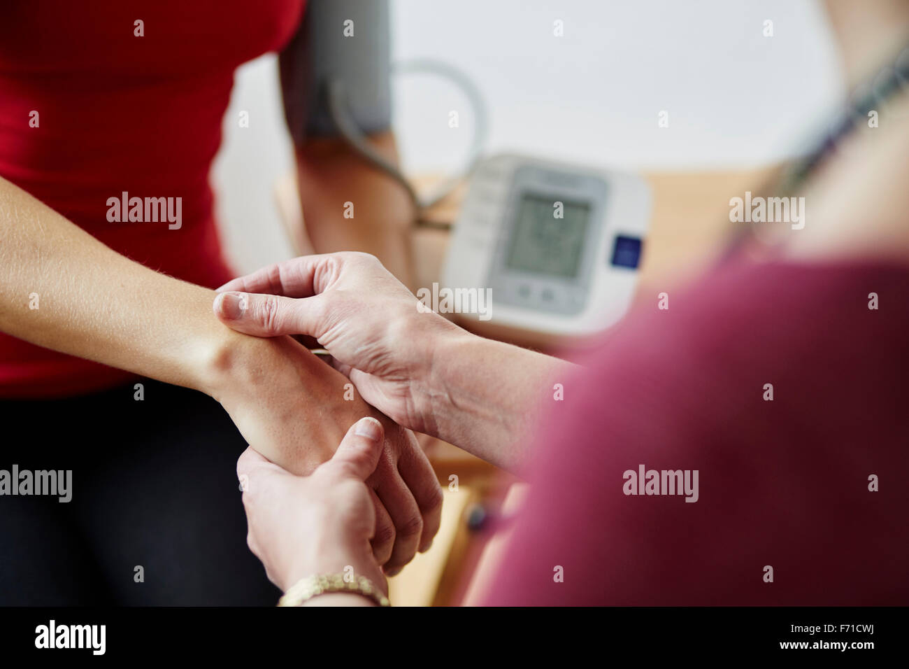 Doctor taking patients bloody pressure Stock Photo