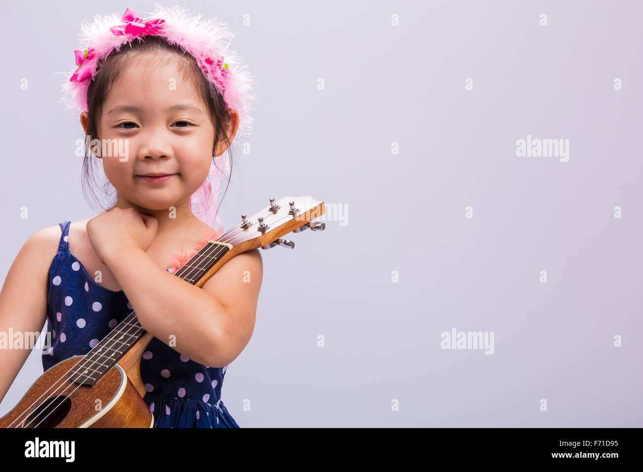 Little girl with her ukulele, string music instrument Stock Photo Alamy