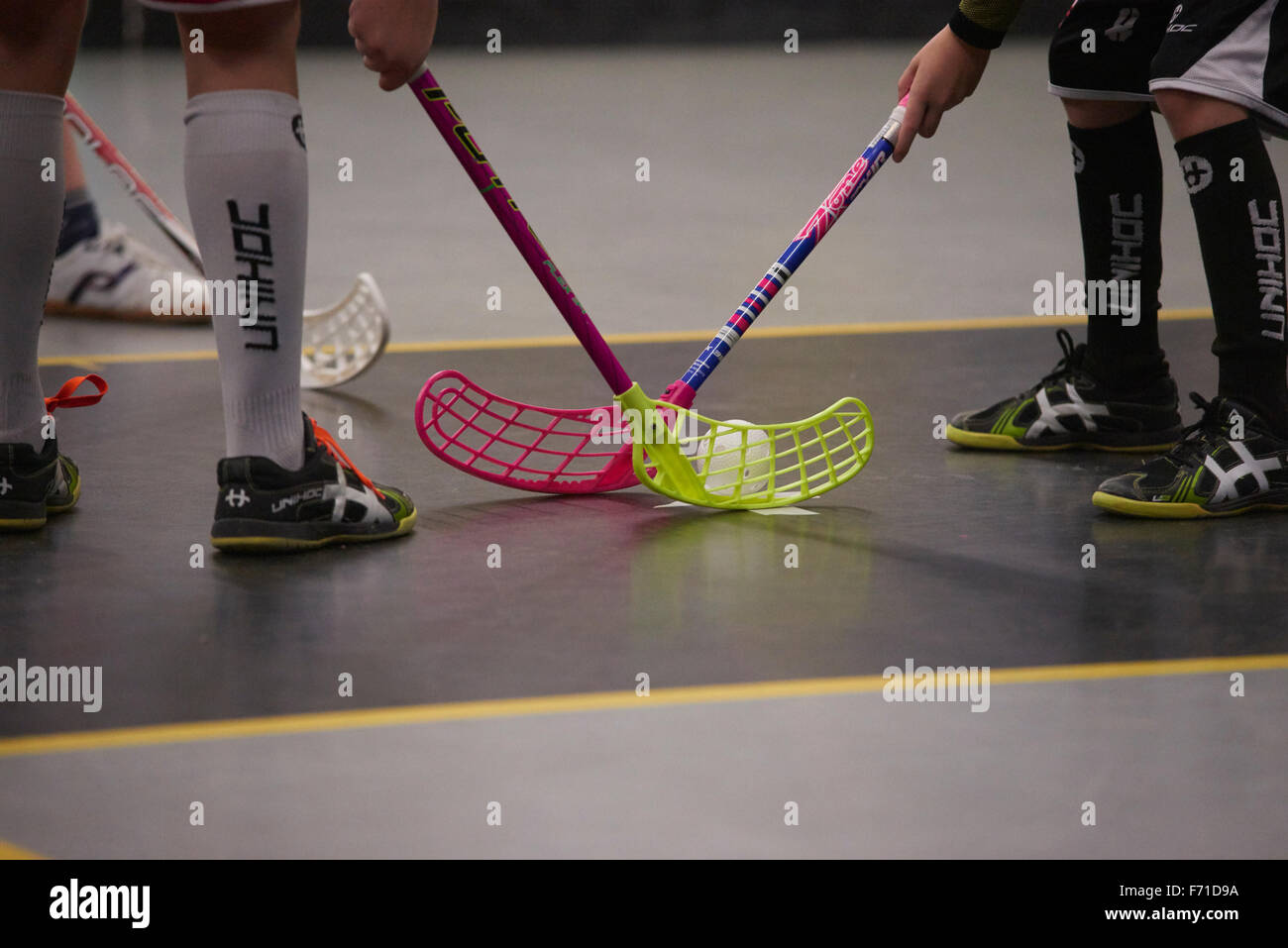 Children boys schoolchildren playing floorball (floor hockey) match in