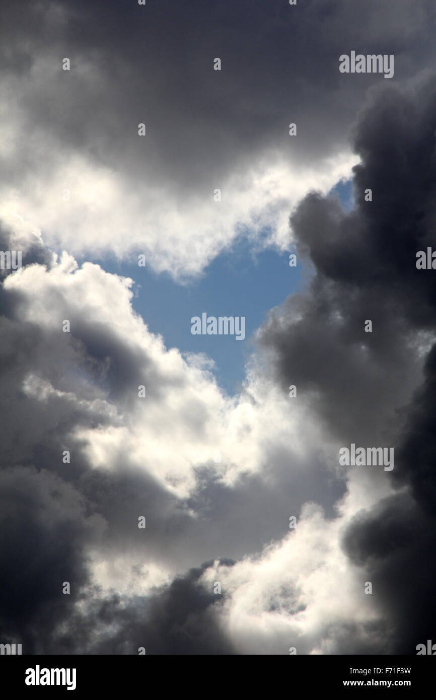 heart shape blue sky in dark clouds in sky Stock Photo - Alamy