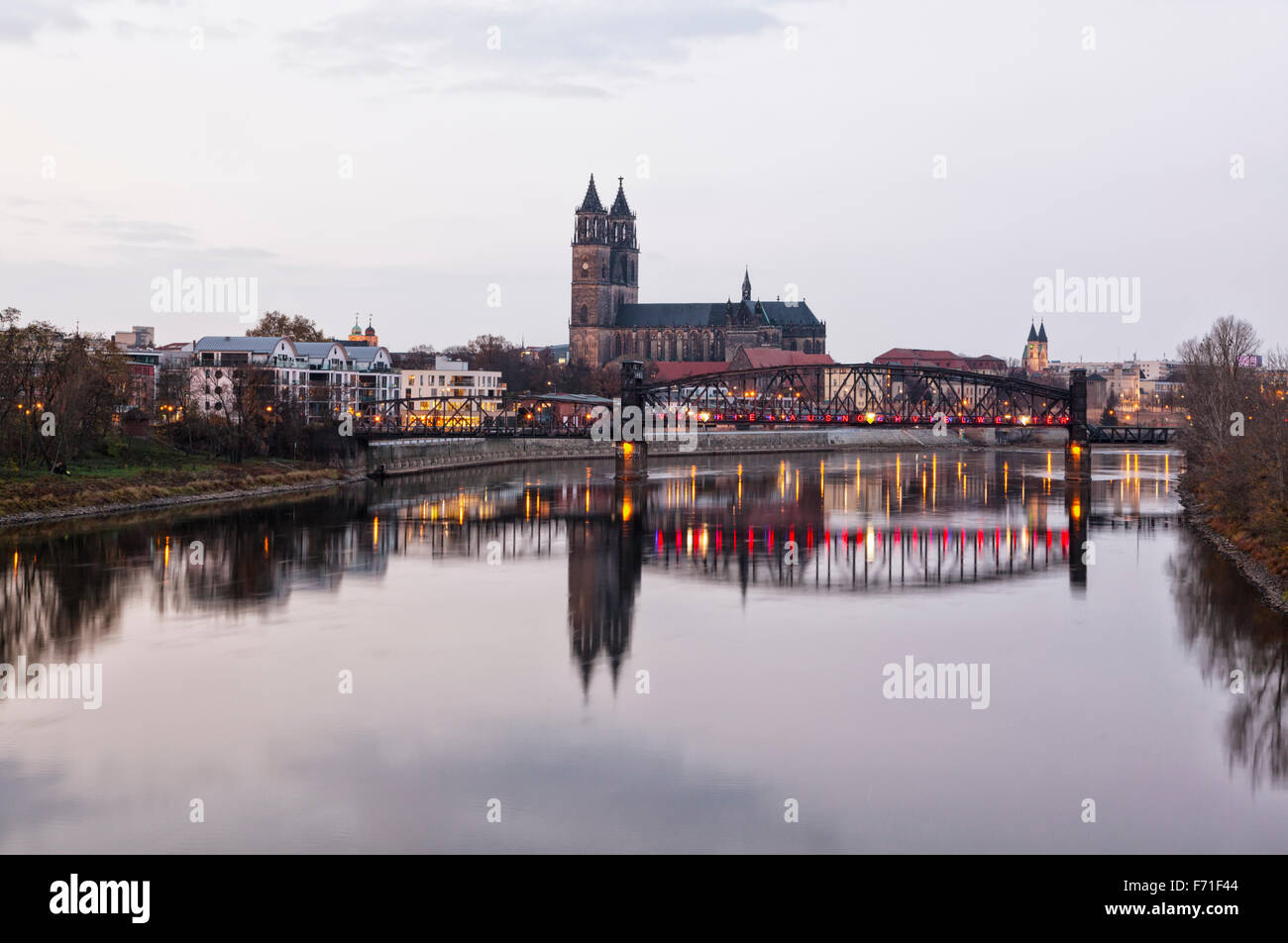 Magdeburg, cathedral and historic vertical-lift bridge across the Elbe river at dusk Stock Photo