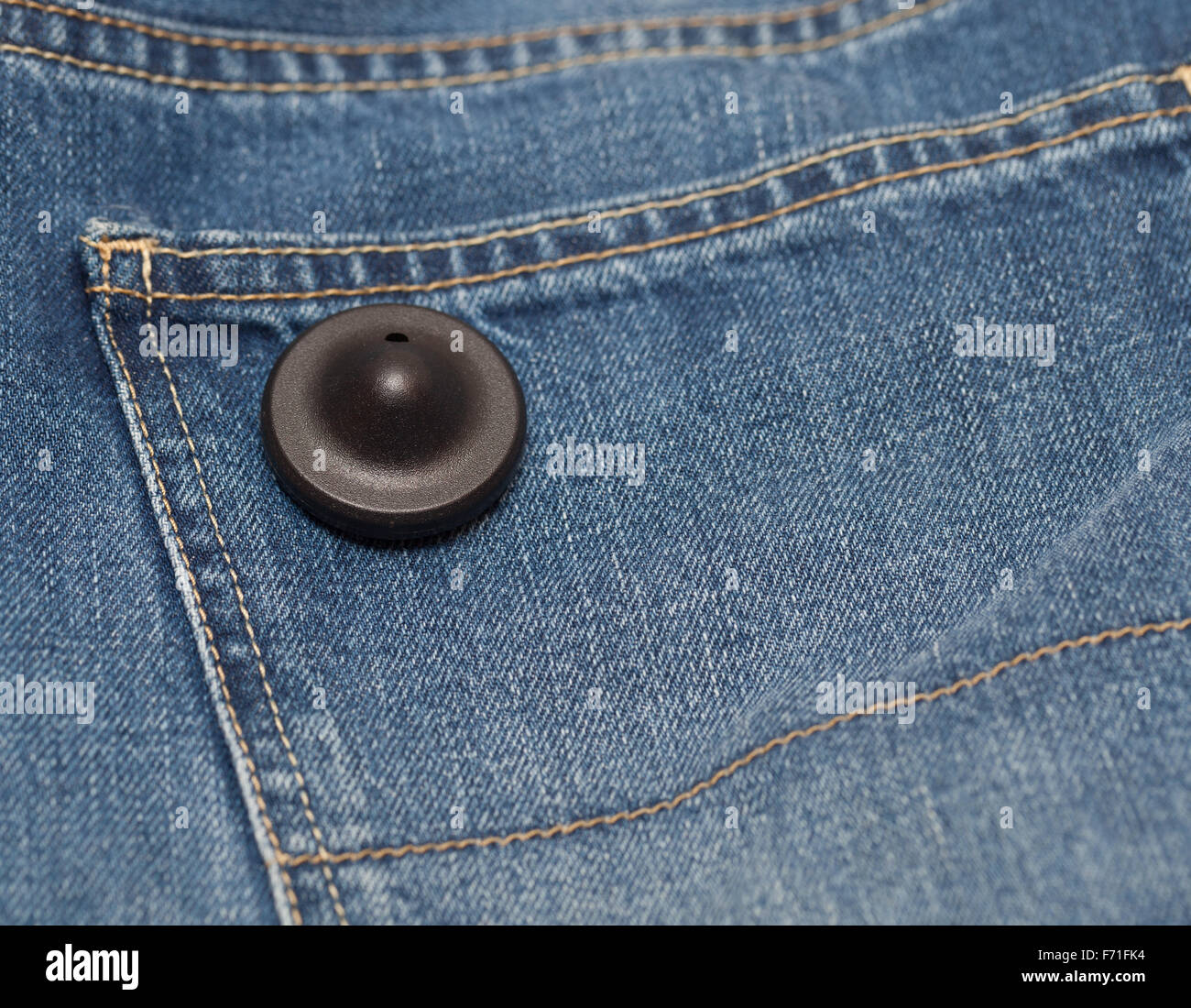 Black round clothing security tag Stock Photo - Alamy
