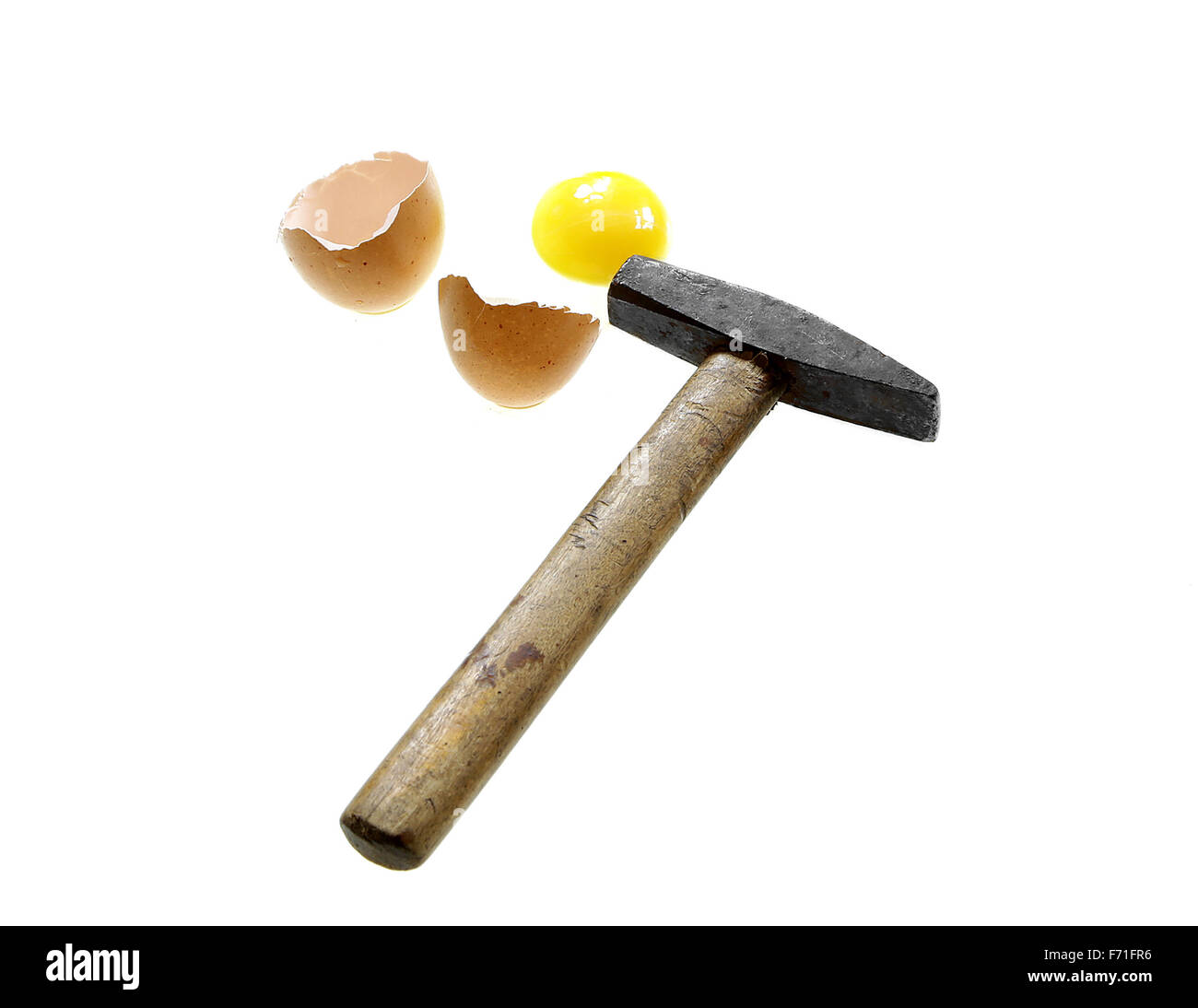 you can't make an omlet without braking a few eggs proverb hammer broken egg isolated on white background Stock Photo