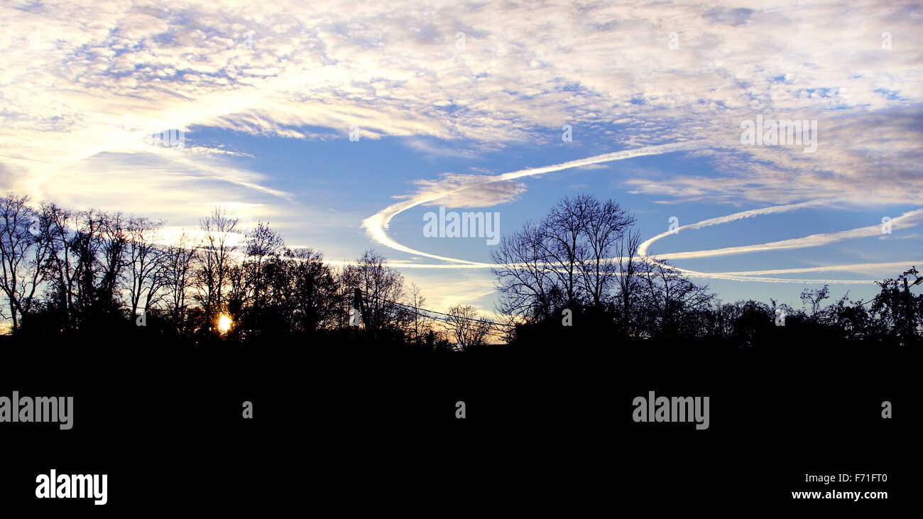 three bent airplane traces on colored sky Stock Photo